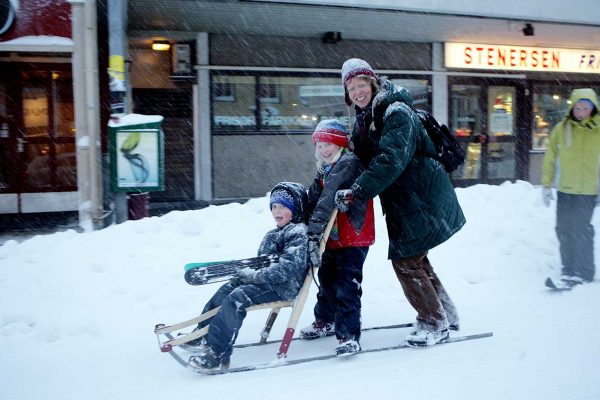 two children and one adult on kicksled. photo.